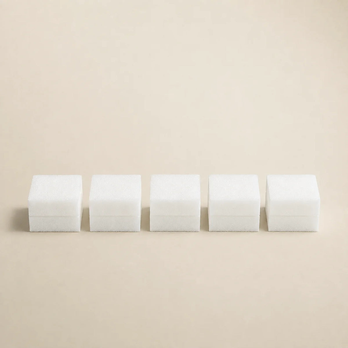 Vijf witte kubusvormige sponsbufferblokken in een rij voor schoonmaken en polijsten buffer blokken 5 stuks